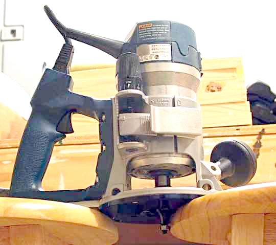 A router with a ball bearing guide fixed to the cutter