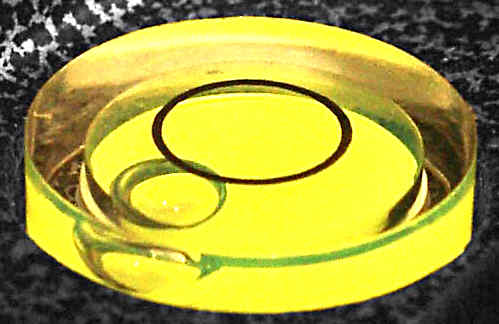 A bullseye level set in a block of clear resin