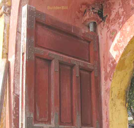 a large timber gate with pivot hinges