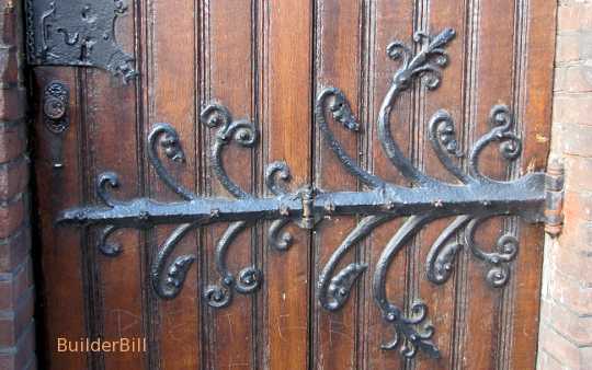 An ornate wrought iron hinge