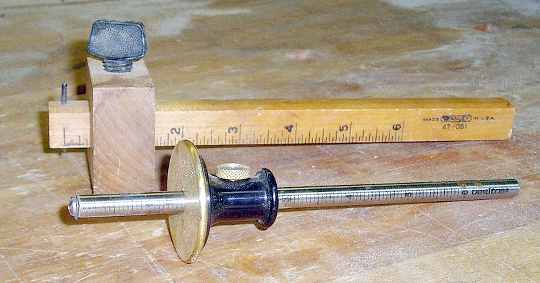A wooden and a steel marking gauge