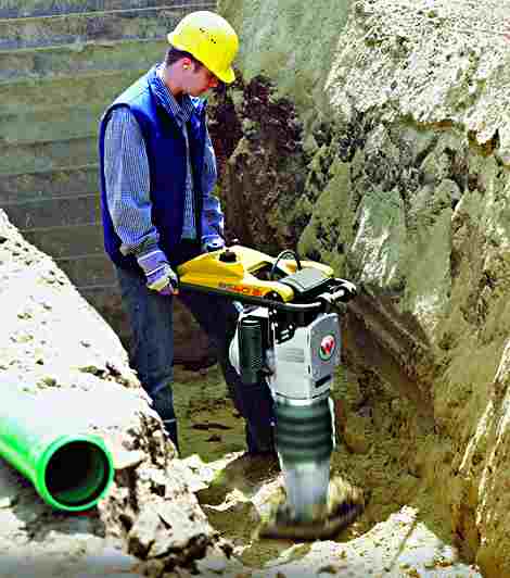 Doing what it does best, a wacker compacting a trench