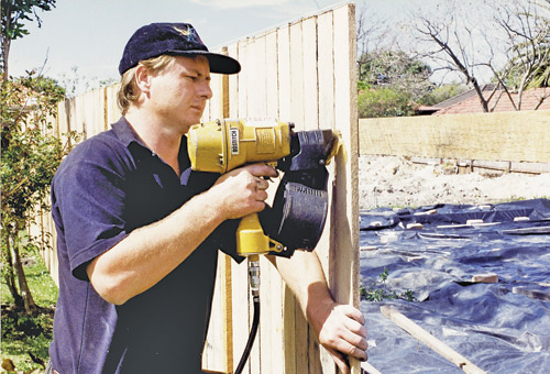 A coil nail gun used in fencing work