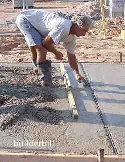 dropping a metal joint into the wet concrete