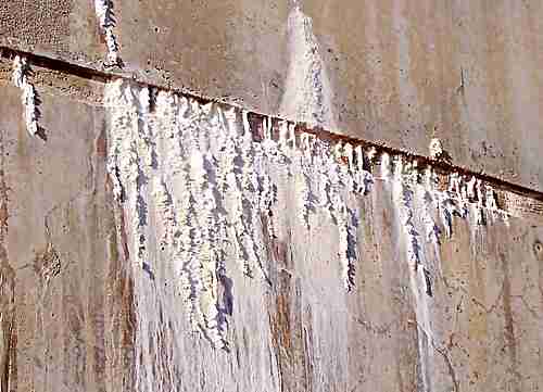 efflorescence on the outside of a concrete water tank