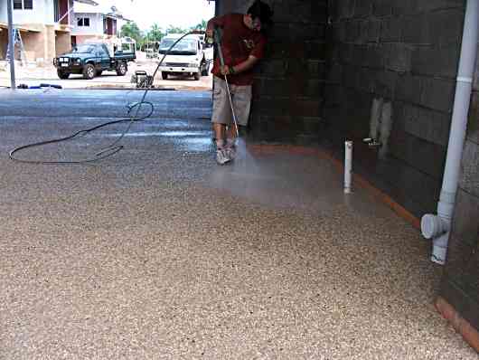 cleaning concrete with a water blaster